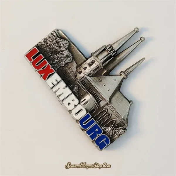 Angled view of the 3D metal Luxembourg cathedral souvenir magnet showing its sculpted spires and depth