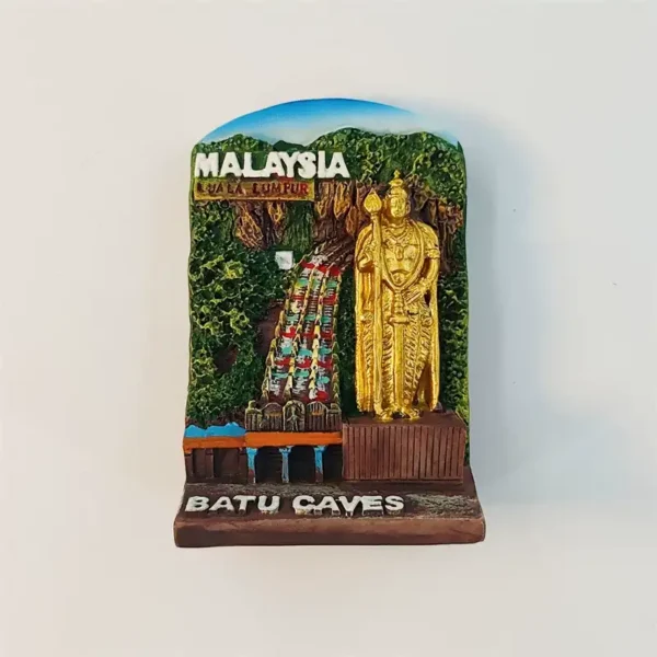 Front view of Malaysia Batu Caves fridge magnet with golden Murugan statue and rainbow stairs