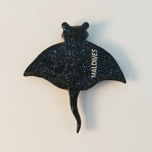 Maldives manta ray fridge magnet in black with blue starry speckles and MALDIVES lettering, front view