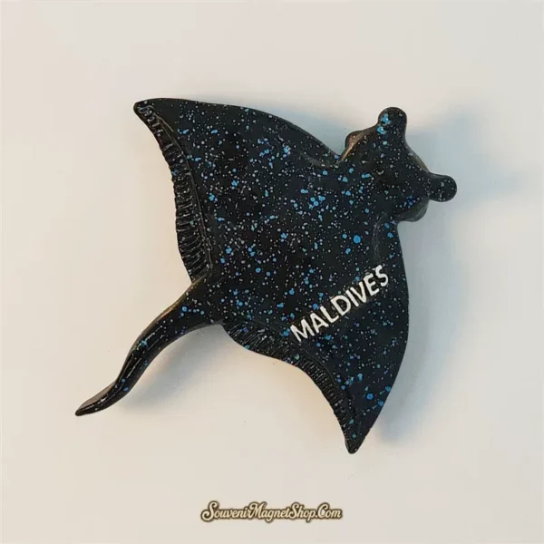 Maldives blue starry manta ray souvenir magnet shown at an angle with galaxy speckled finish