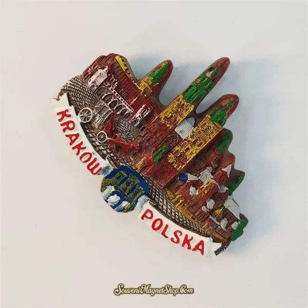 Angled view of the Krakow Polska souvenir magnet showing the layered relief skyline and horse carriage