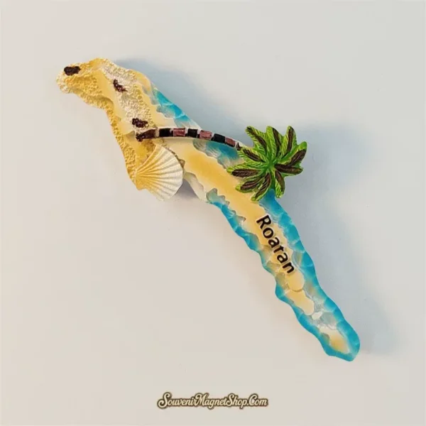 Angled Roatan Island souvenir magnet showing sandy beach, striped palm tree and blue coastline