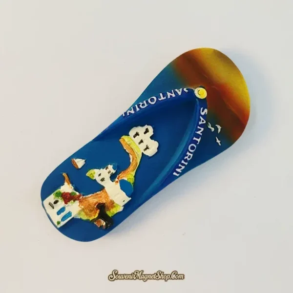 Angled Santorini souvenir flip-flop magnet showing sculpted Greek houses and Aegean blue strap