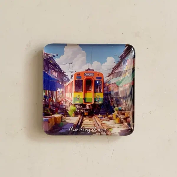 Glass fridge magnet of Thailand Maeklong Railway Market with a colourful Bangkok train and stalls