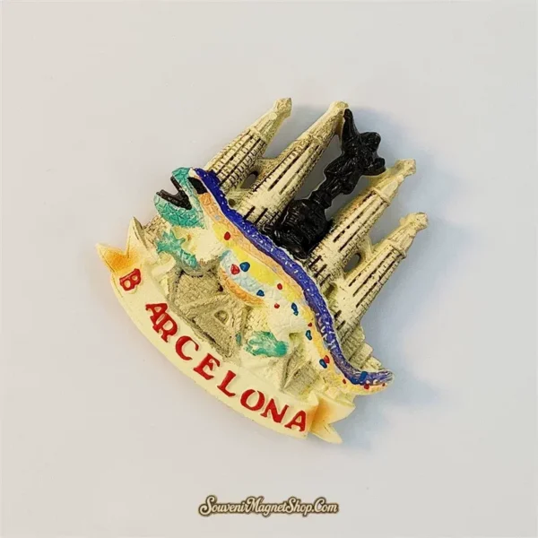Angled view of the Barcelona Sagrada Familia souvenir magnet showing its 3D relief and multicolored mosaic lizard