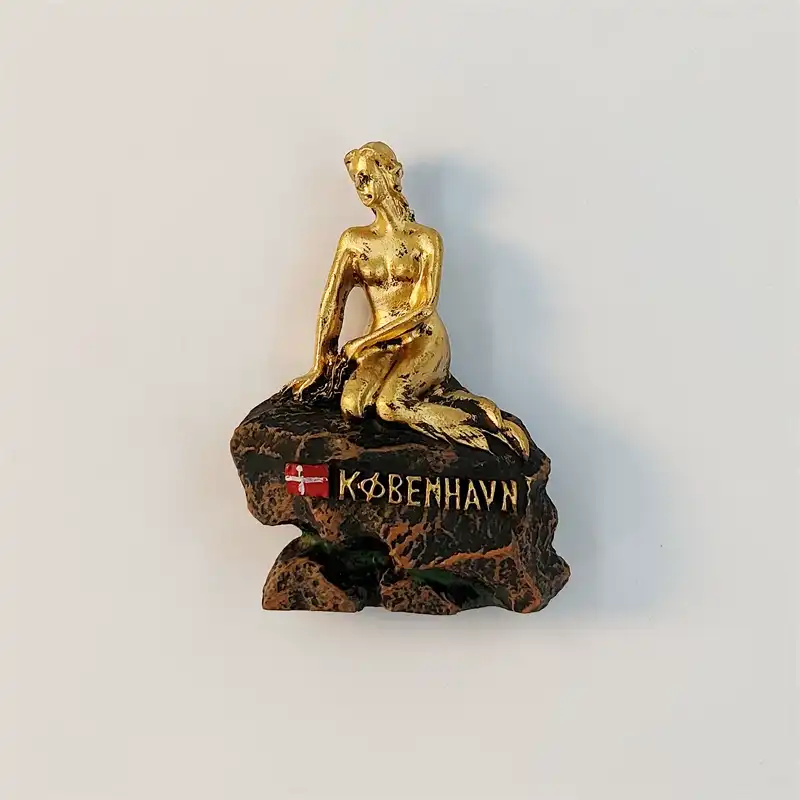 Golden Little Mermaid statue fridge magnet from Copenhagen, front view on a bronze rock with Danish flag and KØBENHAVN lettering