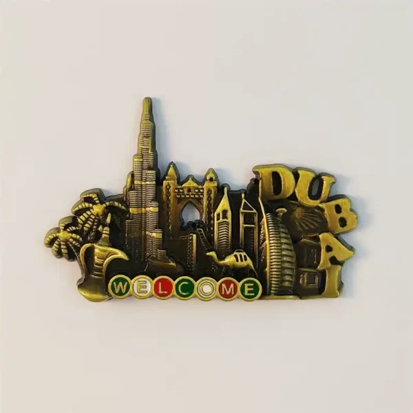 Front view of antique bronze Dubai fridge magnet with Burj Khalifa, Burj Al Arab, palm trees, camel and colorful WELCOME sign