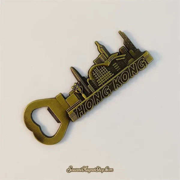 Angled view of a metal Hong Kong skyline souvenir magnet with built-in bottle opener and detailed towers
