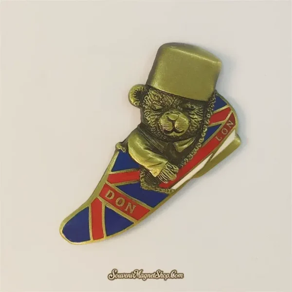 Angled London souvenir magnet showing the bronze top-hat bear on a red, white and blue Union Jack shoe in 3D metal relief