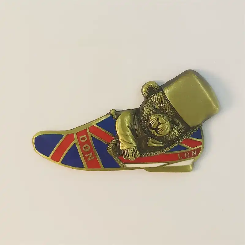 Front view of London fridge magnet shaped like a Union Jack slipper with a bronze top-hat bear and LON-DON lettering in enamel and metal
