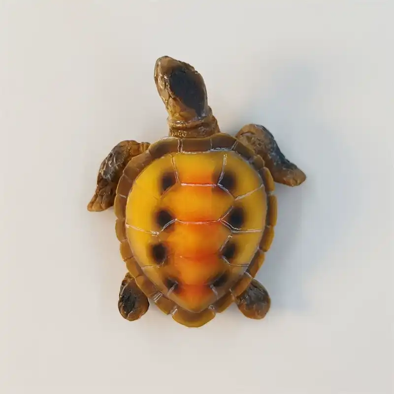 Top view of the 3D Maldives sea turtle fridge magnet with an amber spotted shell and brown flippers