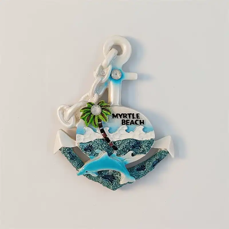 myrtle-beach-anchor-dolphin-fridge-magnet-front Front view of a white Myrtle Beach anchor fridge magnet with a blue leaping dolphin, green palm and teal waves under Myrtle Beach lettering