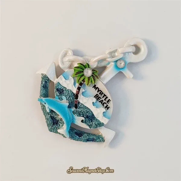 Angled view of the Myrtle Beach dolphin souvenir magnet showing its 3D anchor shape and painted ocean scene