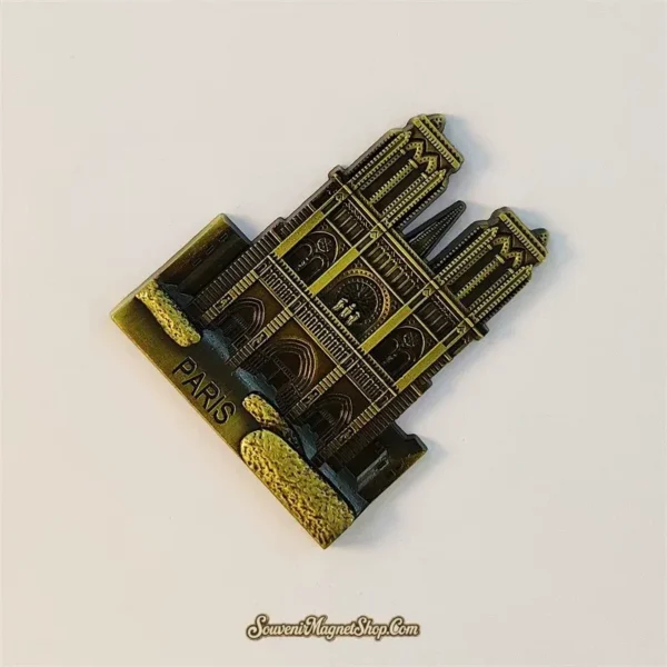 Angled view of Notre-Dame de Paris souvenir magnet showing 3D relief and gothic facade detail