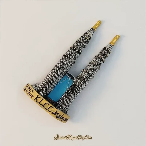 Angled view of 3D KLCC Twin Towers magnet showing ribbed facades and skybridge