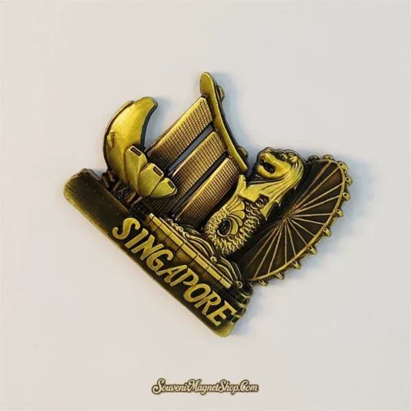 Angled antique-gold Singapore souvenir magnet showing the 3D Marina Bay skyline relief and SINGAPORE text