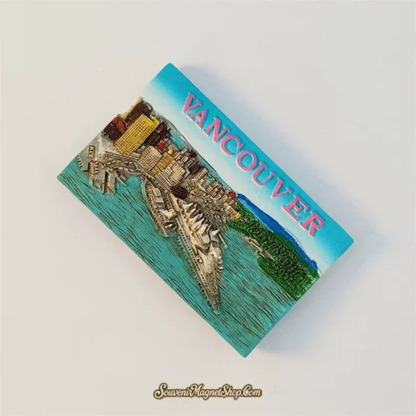Angled view of Vancouver souvenir magnet showing raised downtown towers and thick hand-painted relief