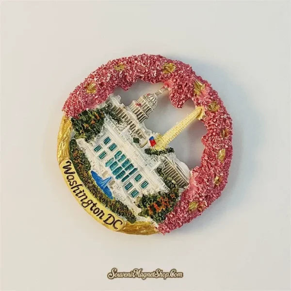 Angled view of the Washington DC souvenir magnet showing the 3D cherry blossom wreath and landmark relief