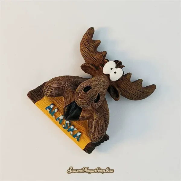 Angled view of cute Alaska moose fridge magnet showing carved antlers and hand-painted fur