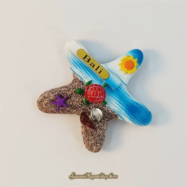 Angled Bali starfish souvenir magnet showing 3D sea turtle, purple starfish and shells