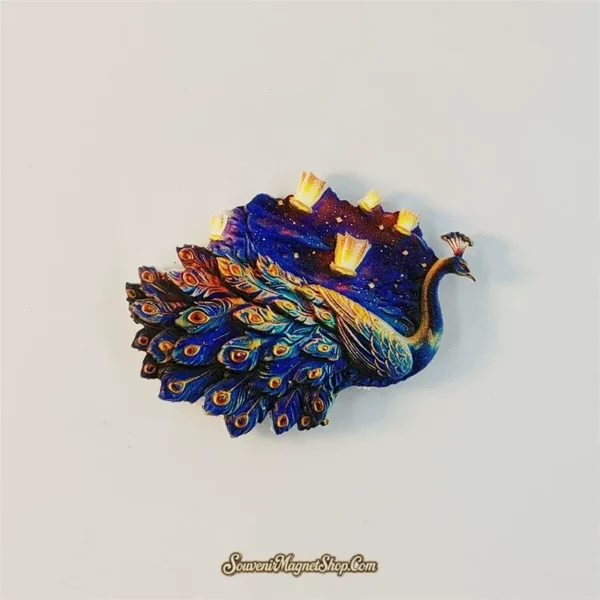 Xishuangbanna souvenir magnet featuring an iridescent peacock under a starry lantern-lit sky
