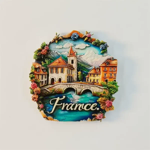 French alpine village fridge magnet with floral border, stone bridge and church tower design