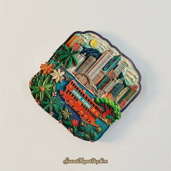 Angled view of a Hong Kong souvenir magnet showing the Victoria Harbour skyline and red double-decker ferry in colorful raised relief