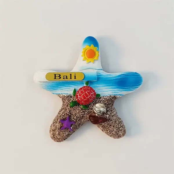 Bali starfish-shaped fridge magnet hand-painted with a beach scene, sea turtle and Bali plaque, front view