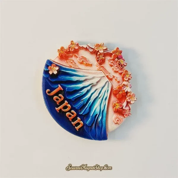 Japan souvenir magnet showing Mount Fuji's snowy blue slope framed by sakura blossoms at twilight