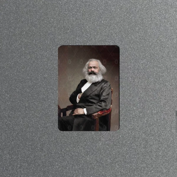 Vintage fridge magnet with a colorized portrait photo of Karl Marx seated in a chair in a dark suit with his signature white beard