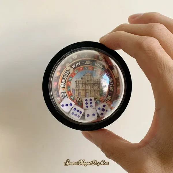 Hand holding Macau dice shaker funny fridge magnet, St. Paul's ruins center