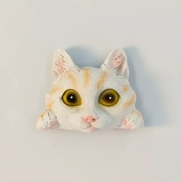 Peeking cat cute fridge magnet, white kitten with ginger markings, big amber eyes and paws on the edge, front view