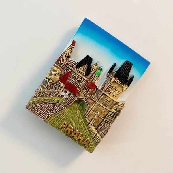 Side view of the 3D Prague Charles Bridge tower gate magnet showing raised stonework and green cobbled road