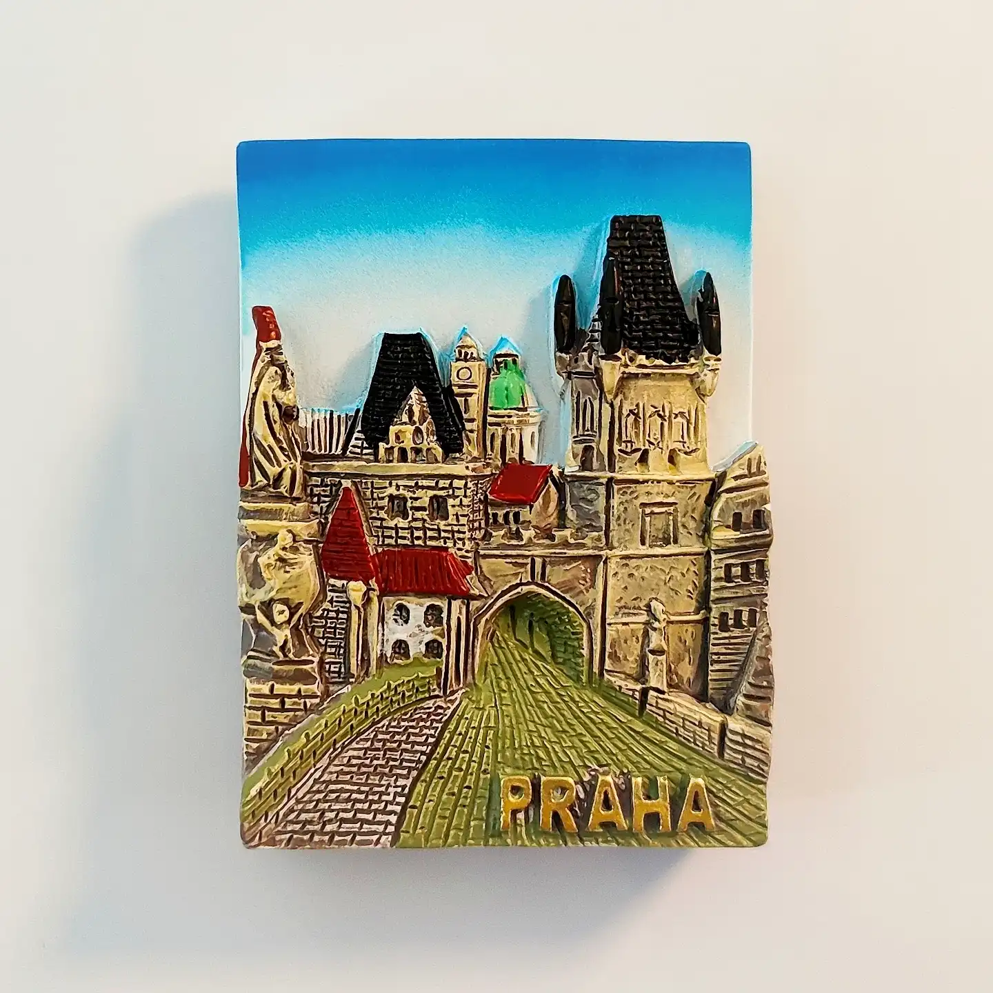 prague-charles-bridge-tower-gate-fridge-magnet-front Hand-painted 3D Prague fridge magnet showing the Charles Bridge tower gate, Gothic archway and cobbled lane