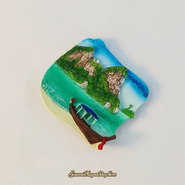 Angled view of Krabi Thailand fridge magnet showing the longtail boat and green karst cliffs