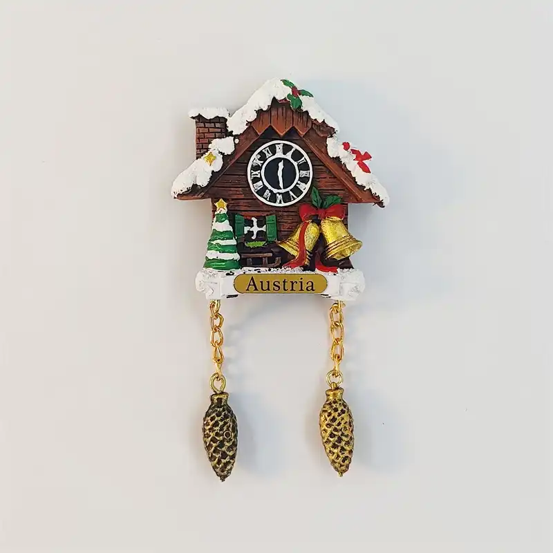 austria-christmas-cuckoo-clock-fridge-magnet-front Austria Christmas cuckoo clock fridge magnet with snowy chalet roof, gold bells, striped tree and pinecone pendants.