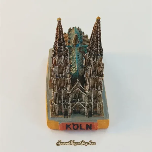 Front view of the Cologne Cathedral landmark figurine with two tall spires, detailed façade and KÖLN base label.