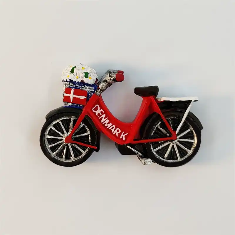 denmark-bicycle-fridge-magnet-front Denmark bicycle fridge magnet with a red DENMARK frame, white daisy basket, Danish flag panel, and black spoked wheels.