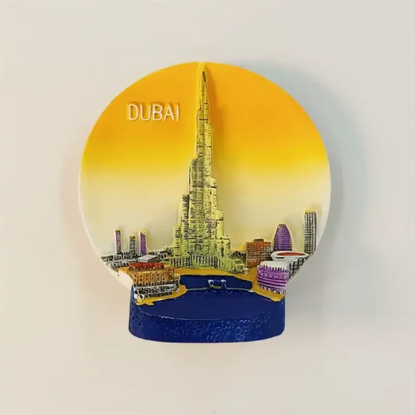 Dubai Burj Khalifa fridge magnet with a raised tower against a golden circular sky, miniature buildings and a deep blue waterfront base.