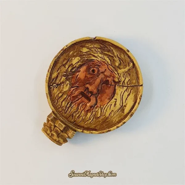 Angled side view of the Rome Mouth of Truth magnet showing the raised gold and copper 3D relief