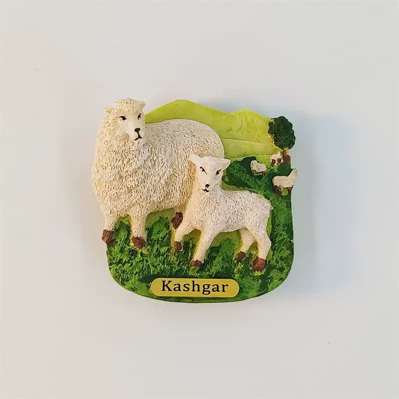 Kashgar sheep and lamb fridge magnet with textured white fleece, green pasture, grazing sheep and yellow nameplate.
