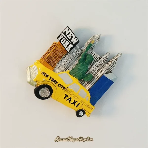Angled New York fridge magnet showing the yellow taxi in front of the Statue of Liberty and silver city buildings.