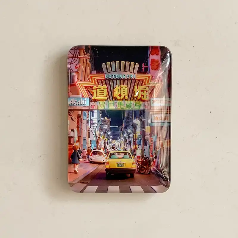 osaka-dotonbori-night-street-fridge-magnet-front Osaka Dotonbori glass fridge magnet with illuminated street signs, a yellow taxi, pedestrians, and a nighttime shopping street.