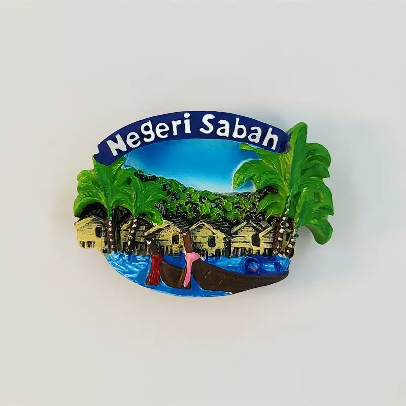 Sabah water village fridge magnet with palm trees, stilt houses, boats and raised Negeri Sabah lettering.