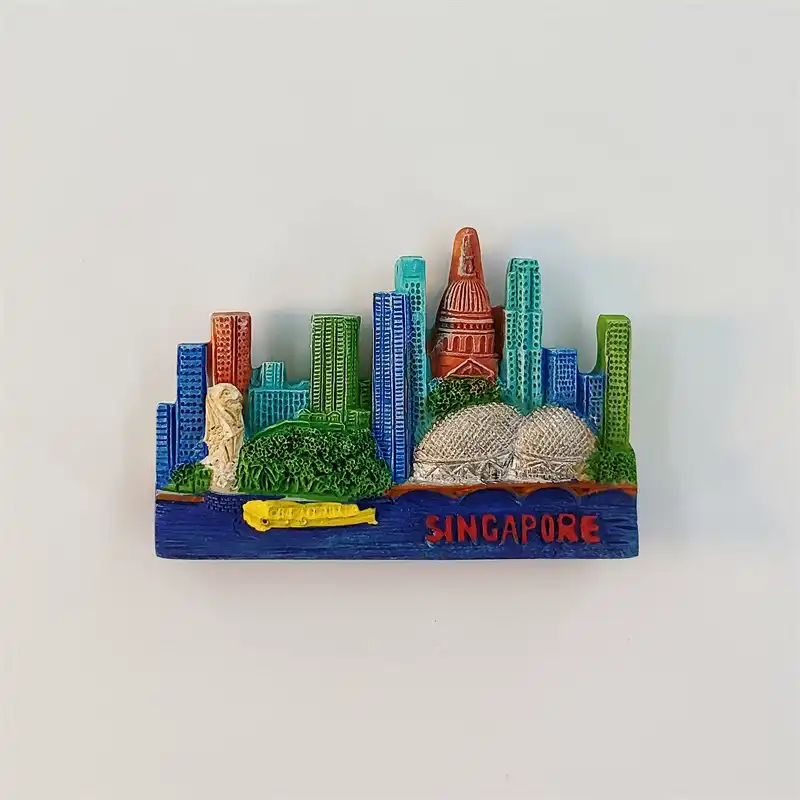 Singapore skyline fridge magnet with the Merlion, twin Esplanade domes, colorful towers and a yellow boat on a blue waterfront.