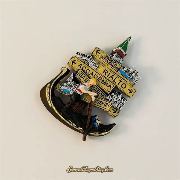 Venice signpost magnet tilted clockwise, showing layered yellow direction signs, miniature landmarks and a gondolier holding a brown oar.