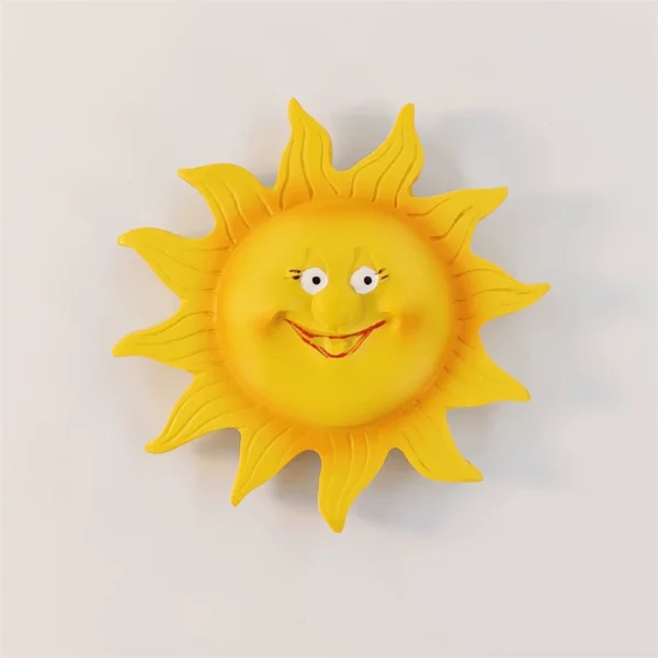 Barcelona smiling sun fridge magnet with a yellow face, wide eyes, red smile, and flowing pointed rays.