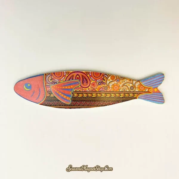 Bohemian Fish A fridge magnet with a pink head, orange paisley body, geometric bands and a blue-striped tail.