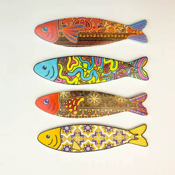 Four aesthetic fish fridge magnet styles: orange paisley, turquoise-faced graffiti, dark floral and yellow floral tile designs.