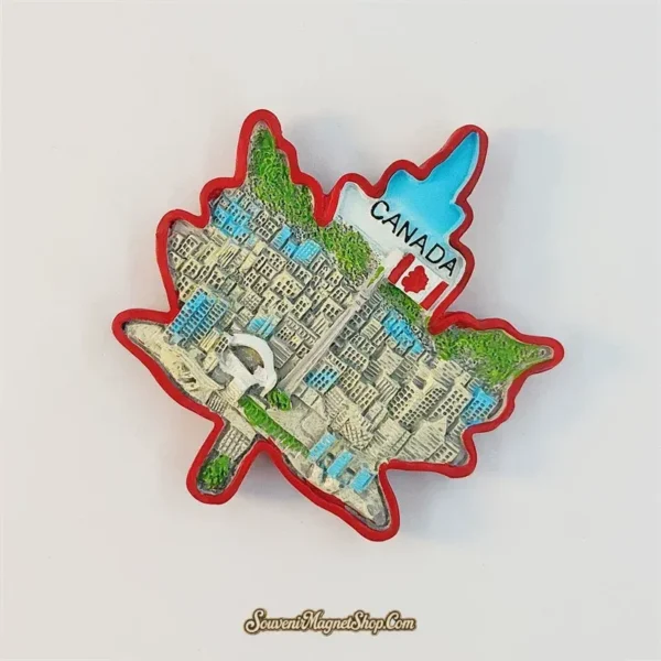 Canada maple leaf fridge magnet tilted clockwise, showing the raised Toronto skyline, Canadian flag and turquoise sky.